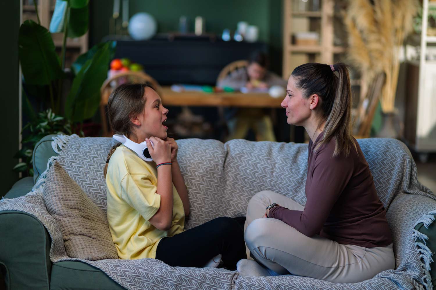 Therapist talking with a child during a Parent-Child Interaction Therapy (PCIT) session, supporting healthy communication, emotional regulation, and stronger family relationships.