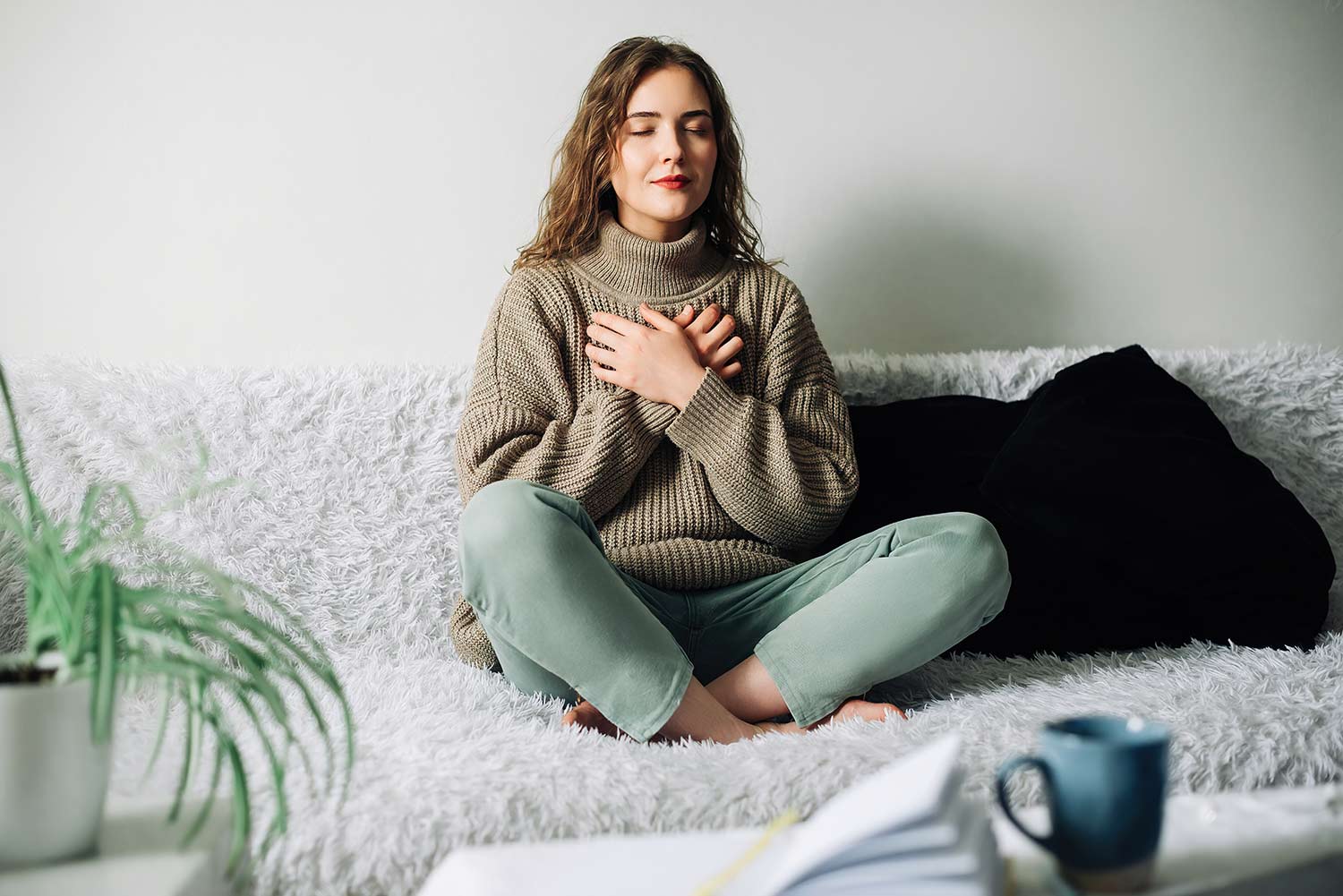 Woman engaging in a mindfulness exercise at home, illustrating anxiety therapy techniques, emotional healing, stress reduction, and mental wellness.