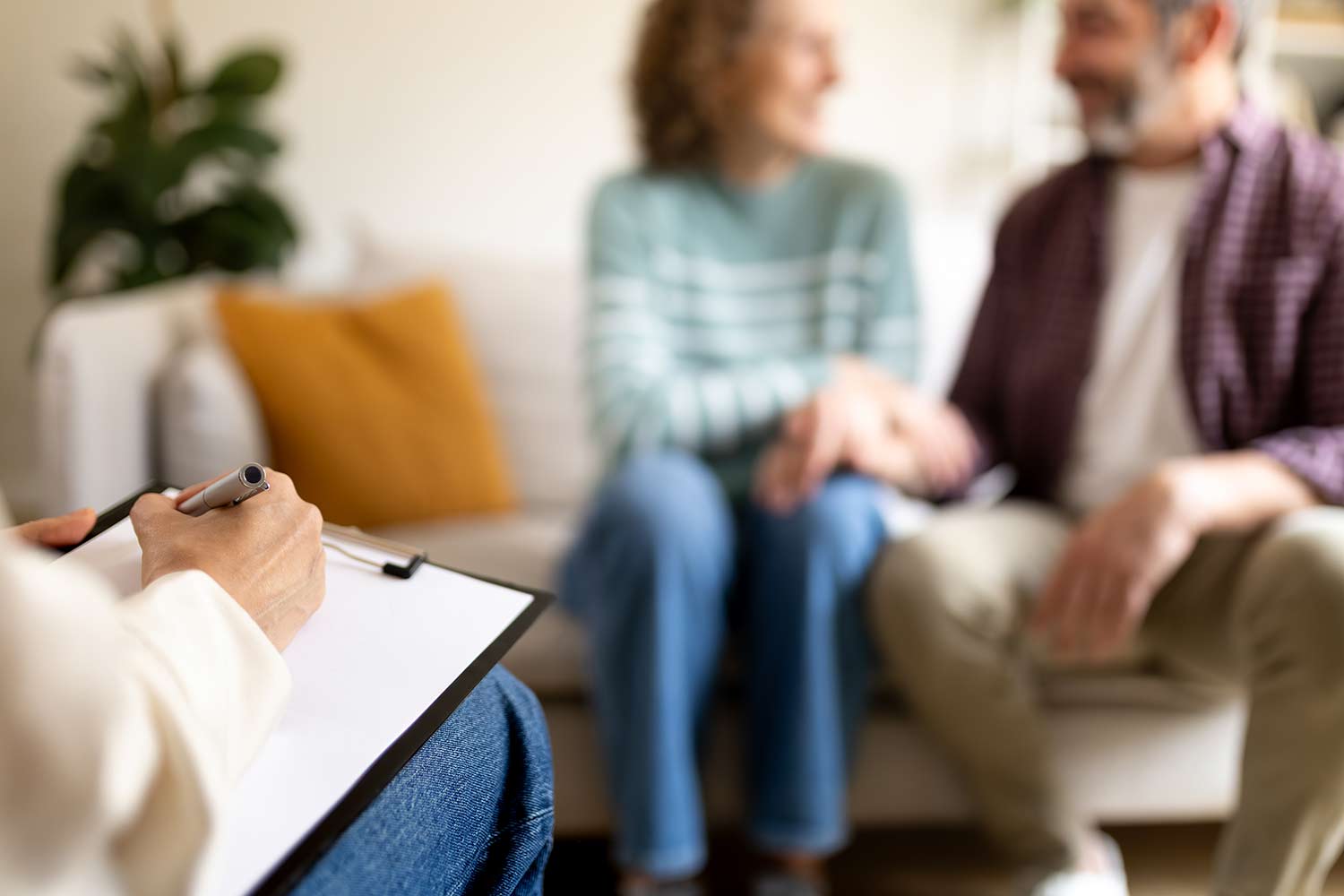 Couple participating in a marriage counseling session with a licensed therapist to improve communication and strengthen their relationship.